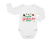 a white long sleeved bodysuit with a holiday message