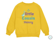 a yellow sweatshirt with the words little cousin henry printed on it