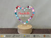 a heart shaped acrylic on a wooden stand