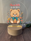 a glass plaque with a teddy bear on it