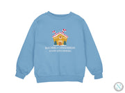 a blue sweatshirt with a gingerbread house on it