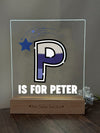 a glass block with the letter p is for peter