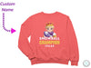 a pink sweatshirt with a picture of a snowball champion on it