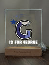 a glass plaque with a picture of the letter c on it